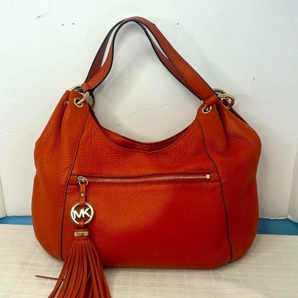 Michael Kors Hobo carryall in tangerine pebbled leather with tassel